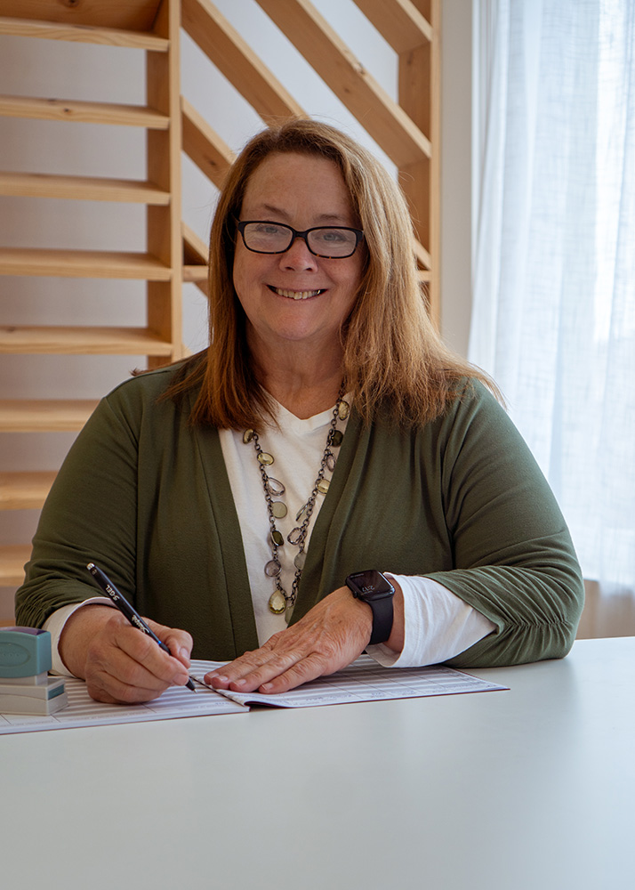 Meribeth Parker using her notary public record book